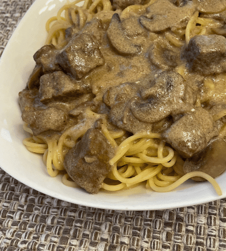 Beef stroganoff with mushroom and creamy sauce over noodles