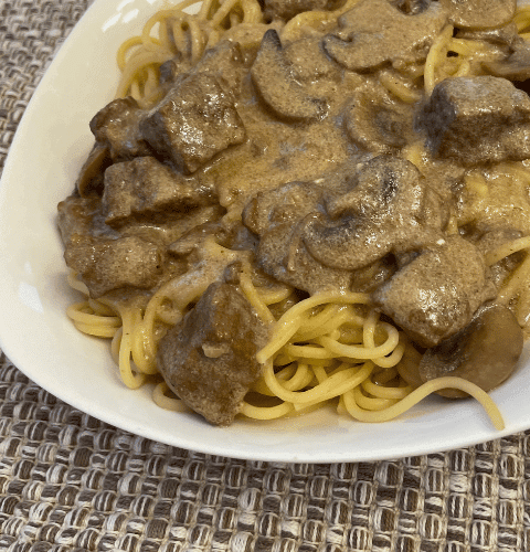 Beef stroganoff with mushroom and creamy sauce over noodles