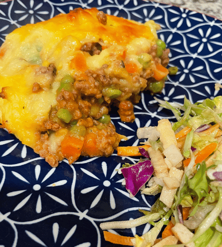 Plated cottage pie with side salad
