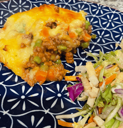 Plated cottage pie with side salad